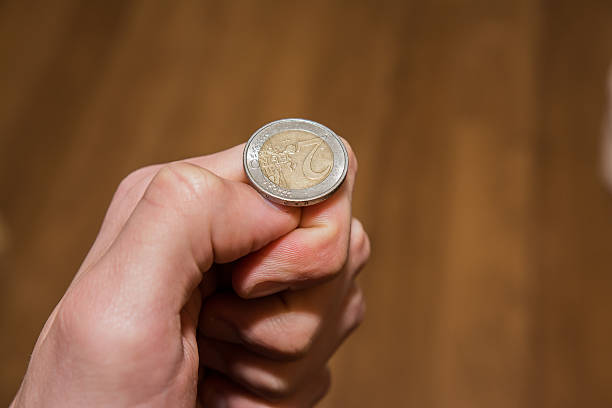 istock A hand getting ready to flip a euro coin 466105070