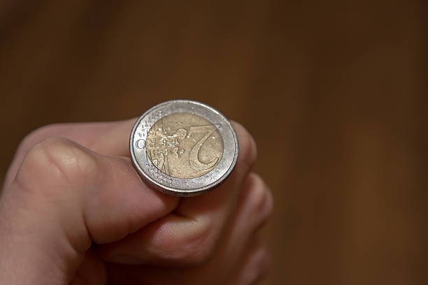 istock Tossing Euro coin 466105072