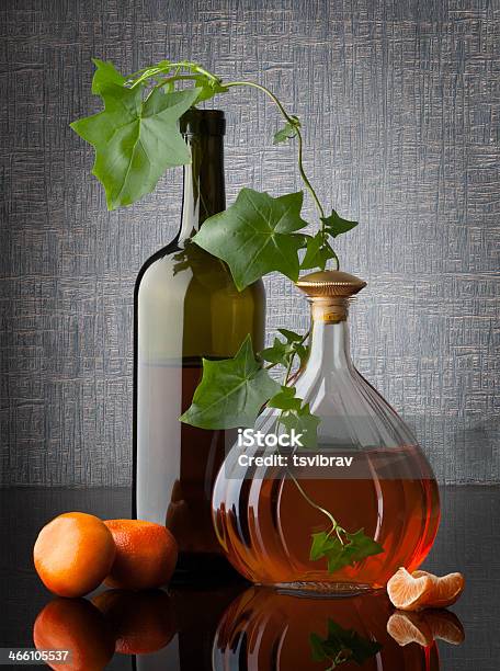 Still Life Composition With Bottles Leafs And Mandarins Stock Photo - Download Image Now