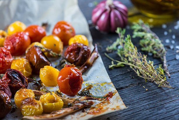 istock Freshly roasted vegetables with herbs on wooden table 466110376
