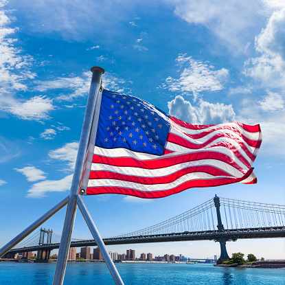 Manhattan Bridge with American flag from Brooklyn New York city US