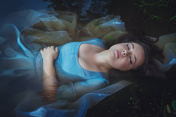istock Young beautiful drowned woman lying in the river 466115498