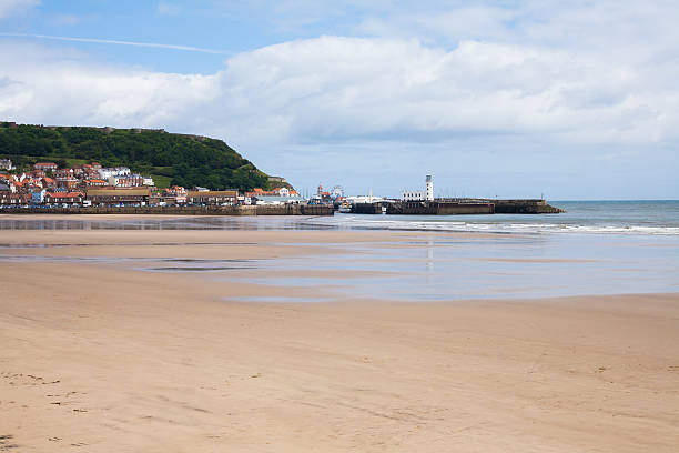 istock Beach and lighthouse at Scarborough 466115514