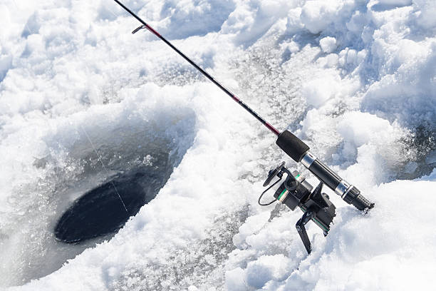 Ice Fishing Hole with Fishing Pole stock photo