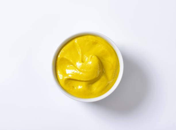 A bowl of smooth Dijon mustard stock photo