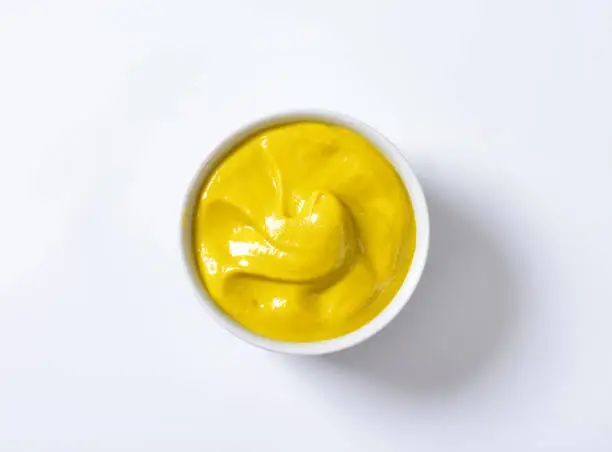 Photo of A bowl of smooth Dijon mustard