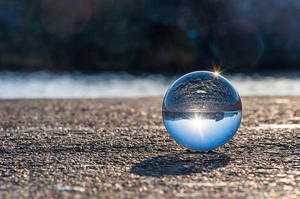 istock Glass transparent ball on dark background and grainy surface 466120656