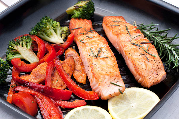 istock Salmon steak with vegetables on pan 466120744