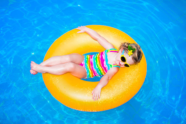 istock Little girl in a swimming pool 466123758