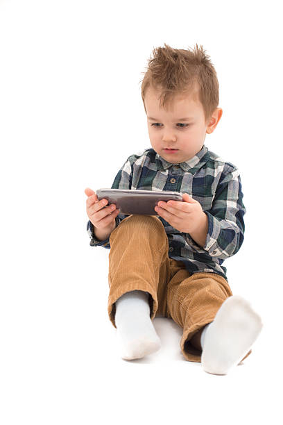 istock Little boy watching cartoons at cell phone 466124054