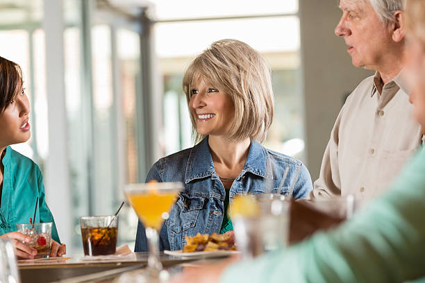 istock Seniors having alcoholic beverages at restaurant bar with friends 466124471