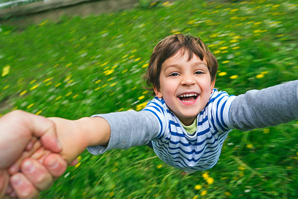 istock Cute boy laughing being spun around 466125144