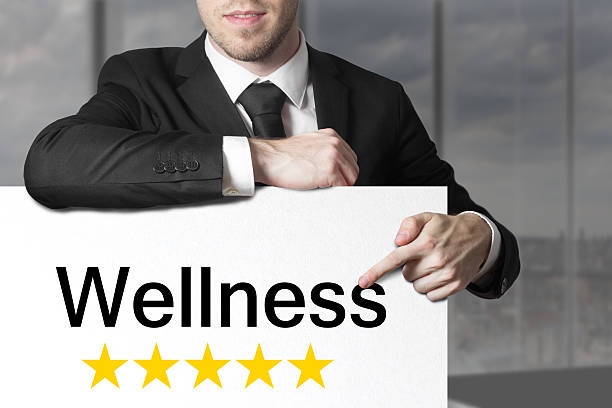 istock businessman pointing on sign wellness five stars 466125514