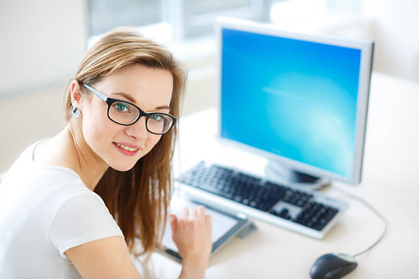 istock Smiling female student or businesswoman using her tablet computer 466126064