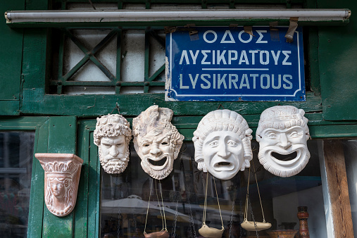 Greek plaster theater masks sold as souvenirs in an Athens street.
