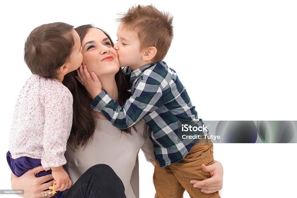 little girl and boy kissing their mother 2015 Stock Photo