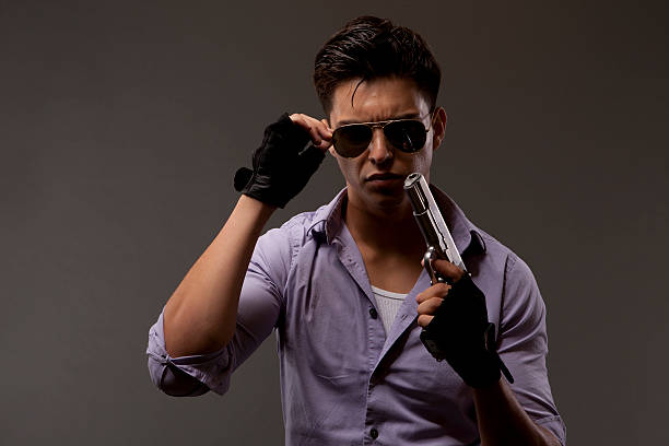 istock shooter with gun removing glasses 466131410
