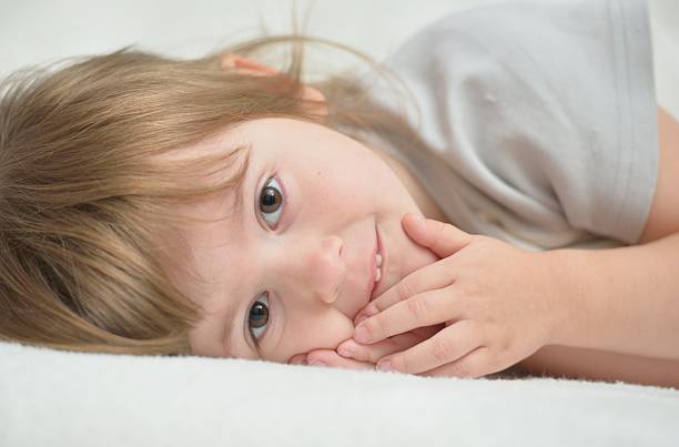 istock Beautiful little girl on white blanket 466131829
