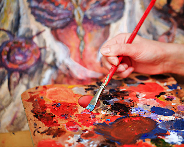 istock Artist's hand Paint a picture 466132900