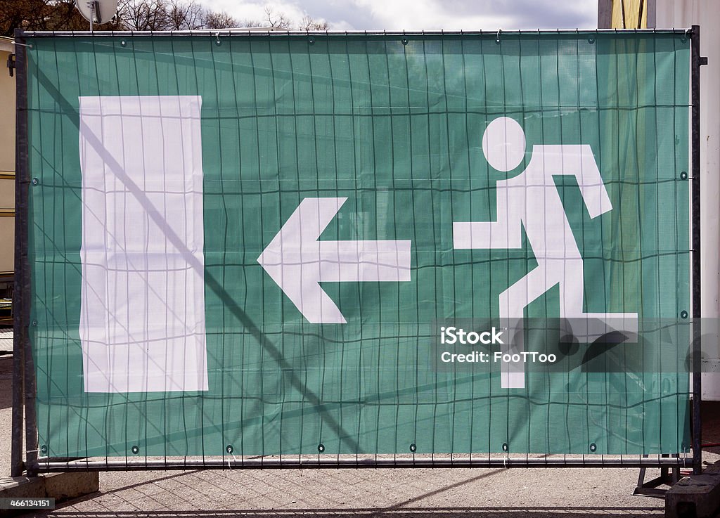 emergency exit sign emergency exit sign at a fence Arrow Symbol Stock Photo