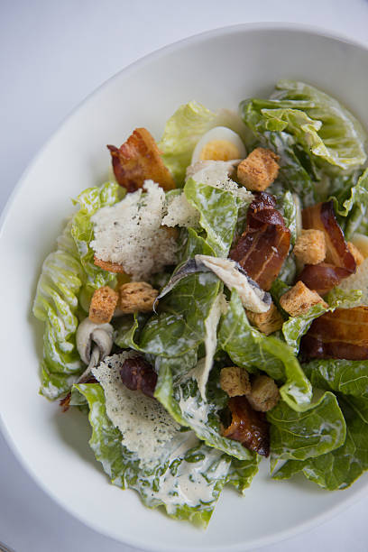 istock Chicken caesar salad with quails egg, pancetta and parmesan crisps. 466137490