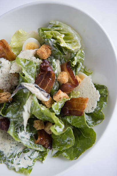 istock Chicken caesar salad with quails egg, pancetta and parmesan crisps. 466137492