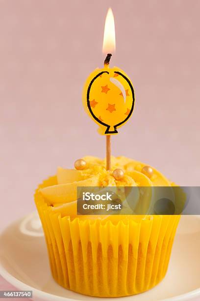 Lemon Cupcake With Butter Cream Swirl And Balloon Candle Stock Photo - Download Image Now