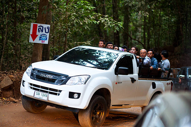 Amphoe, Thailand - February 26, 2015: Early morning shot of passing 4x4 shuttle service running fast uphill and downhill. Thai people are on cars. Ride and view downhill after night visit on holy mountain.