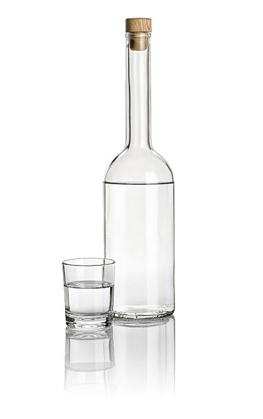 istock Liquor bottle and drinking glass filled with clear liquid 466146434