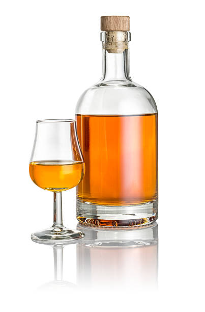 Bottle and snifter filled with amber liquid