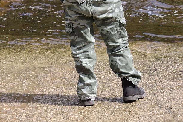 istock child stands on the edge of  stream 466146638