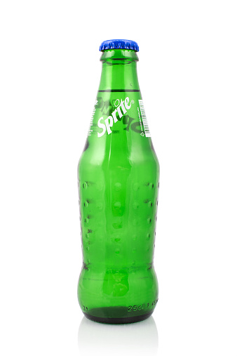 Kragujevac, Serbia - March 6, 2015: Sprite glass bottle on white background. Sprite is a famous colorless, lemon and lime flavored soft drink, created by the Coca-Cola Company.