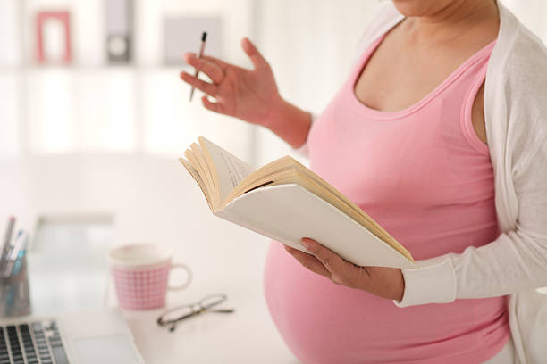 istock Pregnant woman with a book 466150038