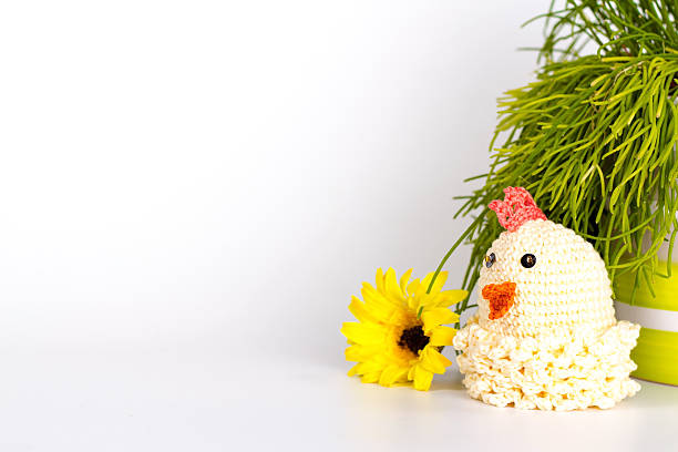 Funny chicken on a white background. Figurine of yellow chicken