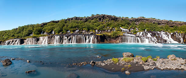Hraunfossar Hraunfossar is a very beautiful Icelandic waterfall in the west of the island. It comes from the lava field and pours into the Hvita river with a incredibly blue water. Long exposure. hraunfossar stock pictures, royalty-free photos & images