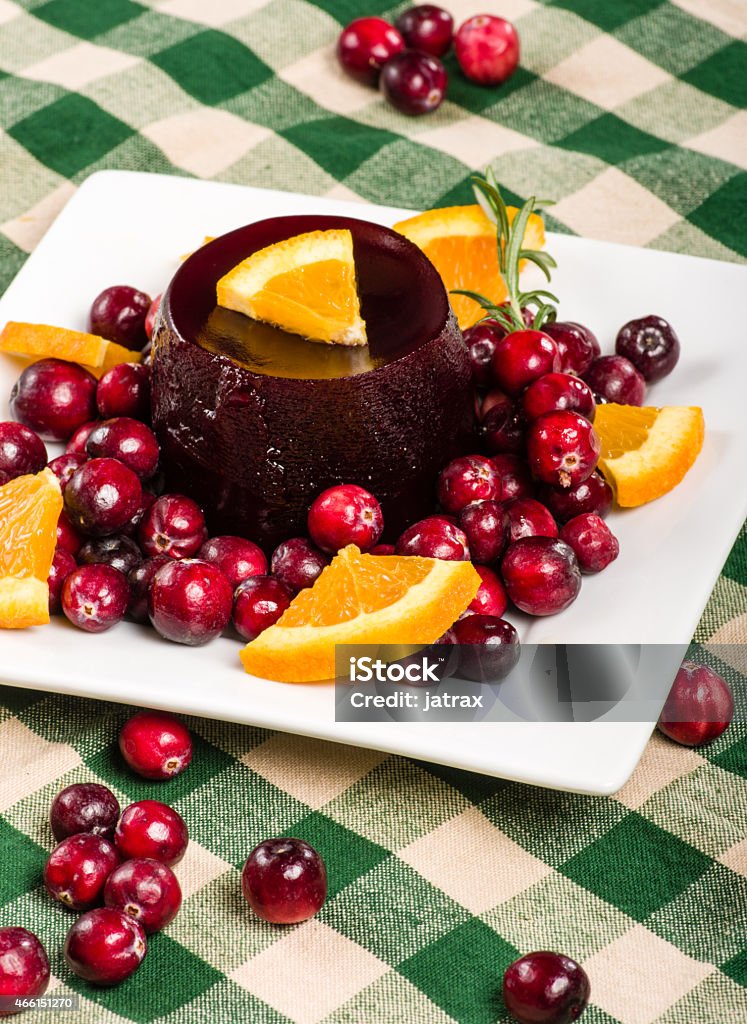 Jellied cranberry sauce with orange wedges and rosemary Jellied fresh cranberry sauce with orange wedges and rosemary 2015 Stock Photo