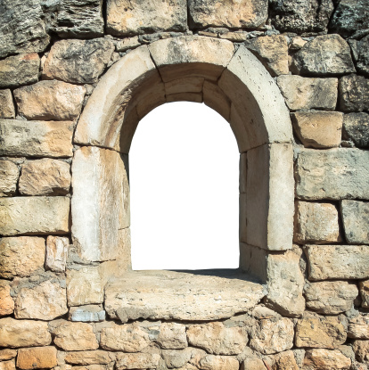 View through stone frame - window hole in an old wall. Window border in an ancient wall - arched window for framing landscape. Window frame, isolated on white background.