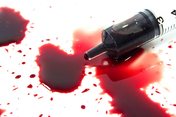 istock Drops of blood and a syringe 466153647