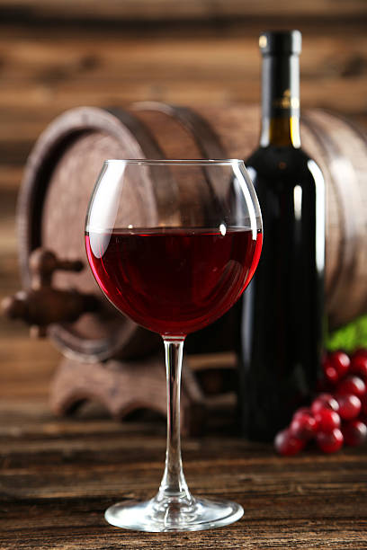 istock Red wine glass with bottle and barrel 466154994