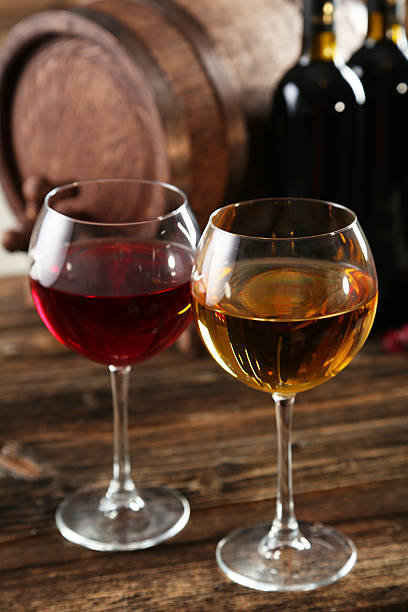 istock Red and white wine glass with bottle and barrel 466155014