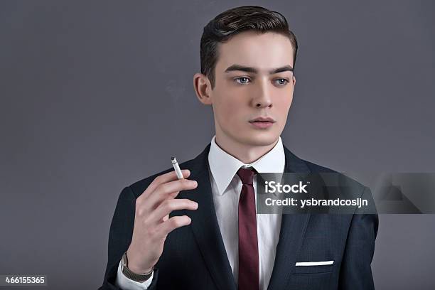 Retro Fifties Fashion Businessman Wearing Dark Suit And Smoking Cigarette Stock Photo - Download Image Now