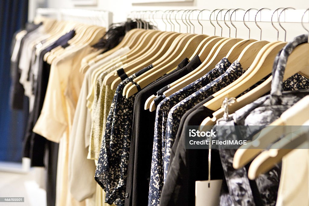 Clothes On a Rack Clothes hang on a shelf in a designer clothes store in Melbourne, Australia Business Stock Photo