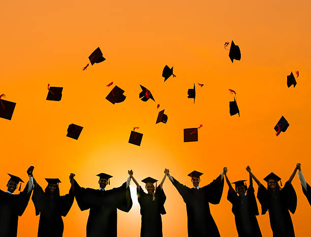istock Graduation Caps Throwing Air Concept 466156284