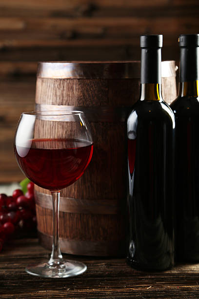 istock Red wine glass with bottle and barrel 466158338