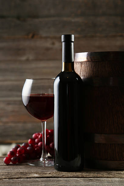 istock Red wine glass with bottle and barrel 466158504