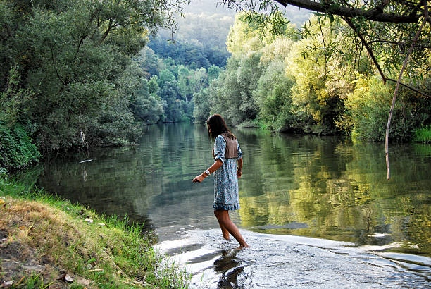 istock Young woman playing with water in lake 466158927
