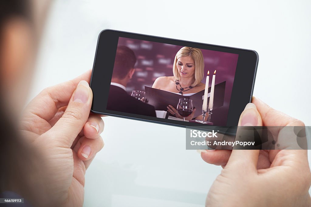 Person Watching Video On Cellphone Close-up Of Person's Hand Holding Cellphone Watching Video Movie Stock Photo