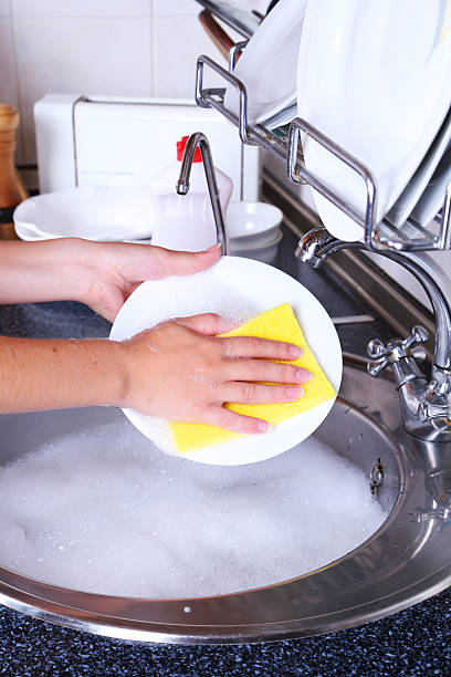 istock Female hand with sponge washing dish 466159140
