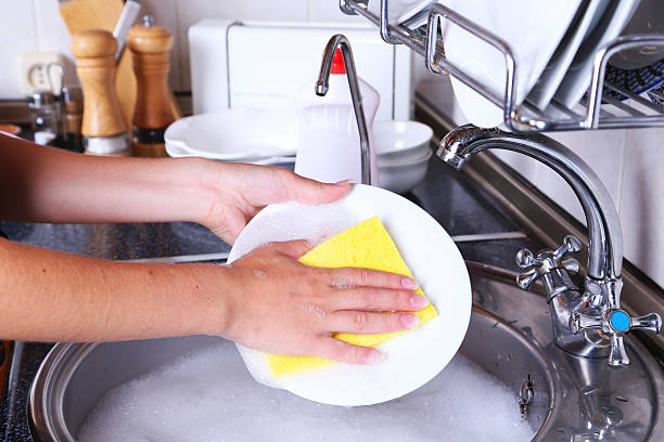istock Female hand with sponge washing dish 466159160