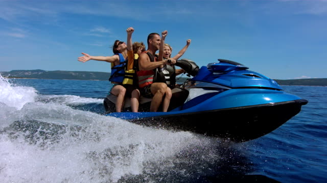 SLO MO Joyful Family Riding A Jet Boat